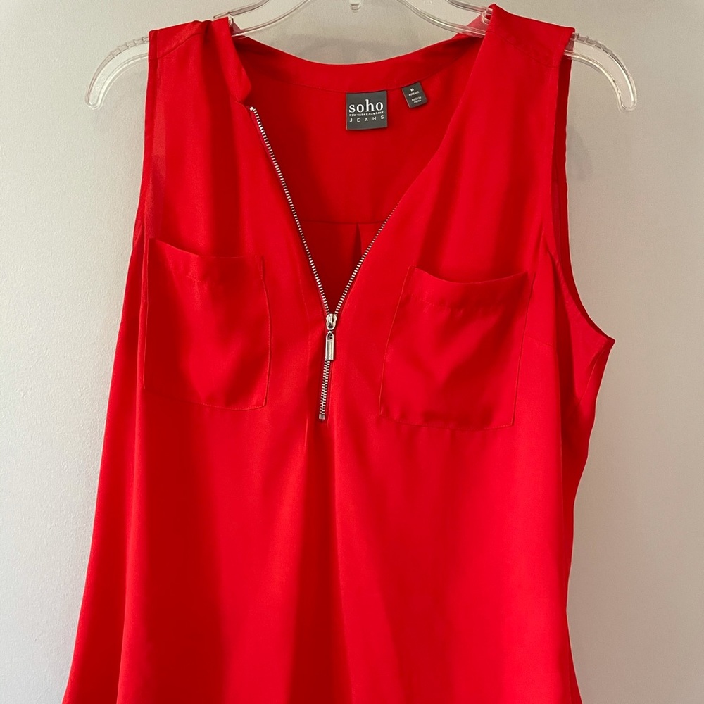 Bright orange sleeveless top with silver zipper